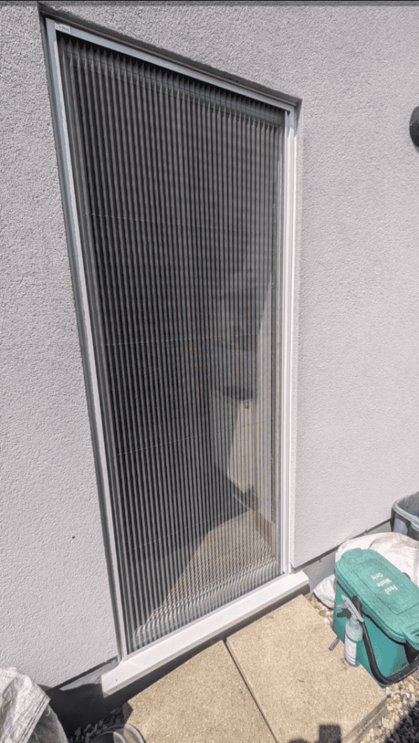 An outside fly screen fitted onto a door.