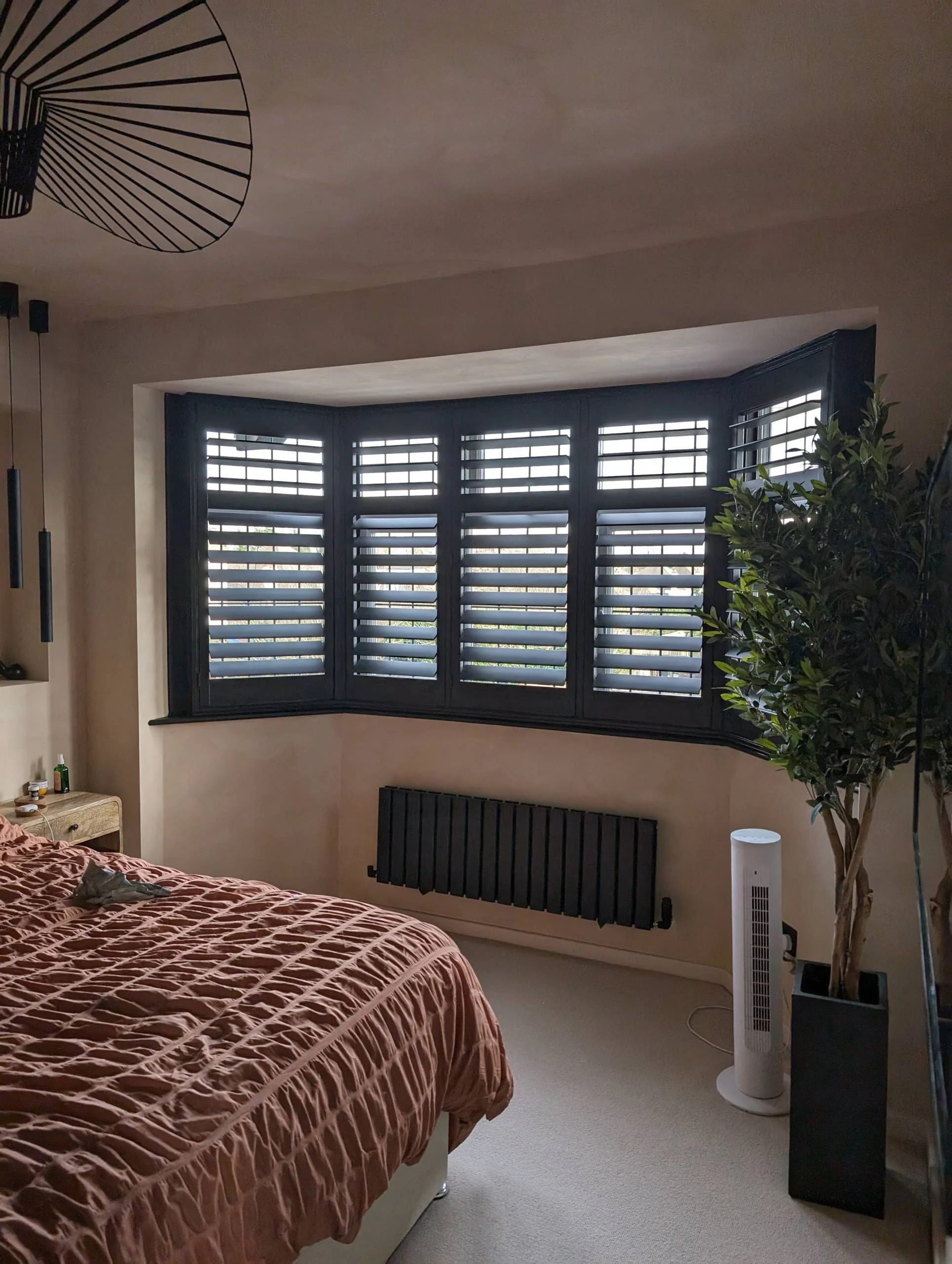 black shutters in a bay window